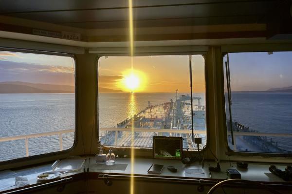Sunset on the horizon from bridge of ship